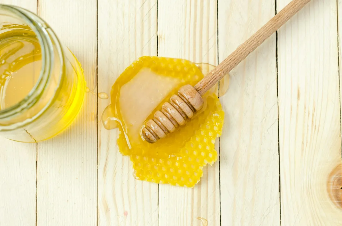 Honey with a wooden dipper